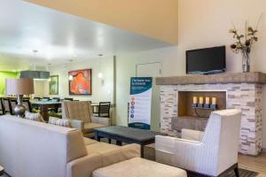 a living room with a couch and a fireplace at Comfort Suites at Tucson Mall in Tucson
