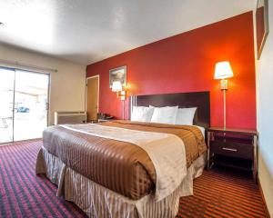 
a hotel room with two beds and a lamp at Rodeway Inn at Lake Powell in Page
