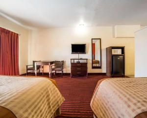 
a hotel room with two beds and a television at Rodeway Inn at Lake Powell in Page

