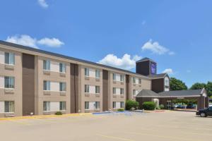 a hotel with a parking lot in front of it at Sleep Inn Fayetteville North in Fayetteville