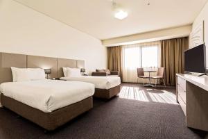 Mantra Melbourne Melton客房内的一张或多张床位