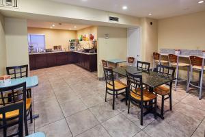 a restaurant with tables and chairs and a kitchen at Quality Inn Parker in Parker