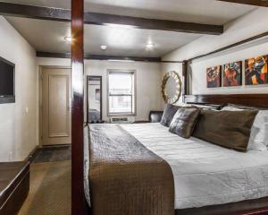 
a bedroom with a large bed and a large window at Rodeway Inn & Suites Williams Downtowner-Rte 66 in Williams
