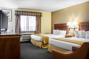 a hotel room with two beds and a flat screen tv at Quality Inn Wickenburg in Wickenburg +15 photos