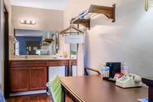 a kitchen with a table and a counter with a telephone at Rodeway Inn near Ft Huachuca in Sierra Vista