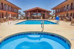 a pool at a resort with chairs and a building at Quality Inn Benson I-10 Exit 304 in Benson