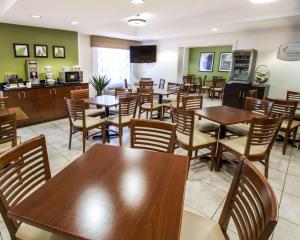 a restaurant with wooden tables and chairs in a room at Sleep Inn at North Scottsdale Road in Scottsdale