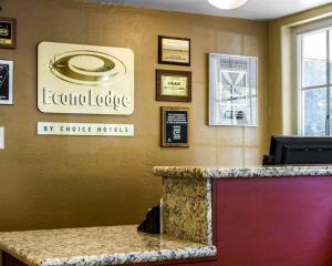 a bar with a clock on the wall and a poster on the wall at Econo Lodge Sacramento Convention Center in Sacramento
