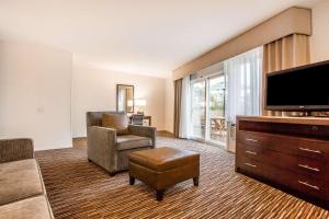 a living room with a tv and a couch and a chair at Quality Inn & Suites Hermosa Beach in Hermosa Beach