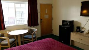 a small room with a small table and a microwave at Rodeway Inn Civic Center in San Francisco