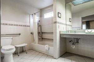 a bathroom with a toilet and a shower and a sink at Quality Inn & Suites Santa Clara in Santa Clara
