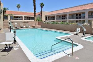 a large swimming pool with chairs and a building at Quality Inn & Suites Indio I-10 in Indio