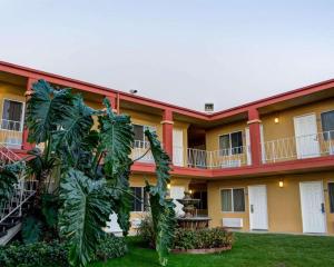 an exterior view of a large building with plants at Rodeway Inn near Venice Beach in Los Angeles