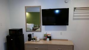 a mirror and a television in a room at Rodeway Inn Civic Center in San Francisco