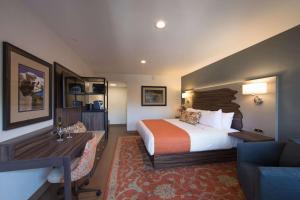 a hotel room with a bed and a desk at The Vine Inn Davis in Davis
