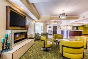 a hotel lobby with a waiting area with a flat screen tv at Comfort Suites Fresno River Park in Fresno