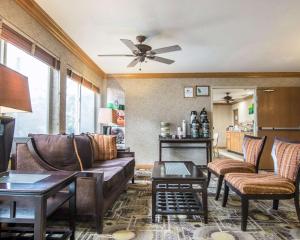 a living room with leather furniture and a ceiling fan at Quality Suites San Diego Otay Mesa in Otay Mesa