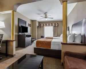 a hotel room with a bed and a flat screen tv at Comfort Suites Bakersfield in Bakersfield +27 photos