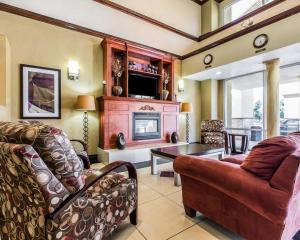 a living room with a couch and a fireplace at Comfort Suites Bakersfield in Bakersfield