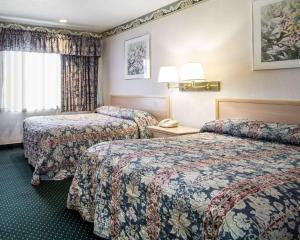 a hotel room with two beds and a phone at Rodeway Inn Monterey Near Fairgrounds in Monterey