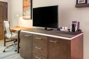 a hotel room with a desk with a flat screen tv at The Cove Hotel in Long Beach