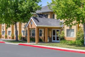 a building on a street with trees in front of it at Quality Inn & Suites in Santa Rosa