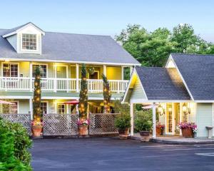 a large yellow house with a porch and a driveway at Baechtel Creek Inn, Ascend Hotel Collection in Willits