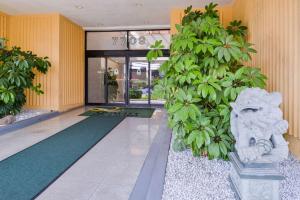 a lobby of a building with a plant at Quality Inn & Suites Montebello - Los Angeles in Montebello