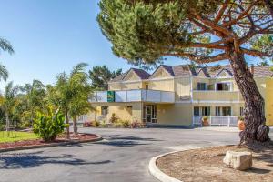 a large building with a tree in front of it at Quality Inn & Suites Capitola By the Sea in Capitola