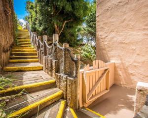 a wooden fence with a wooden gate and stairs at Rodeway Inn Encinitas North in Encinitas