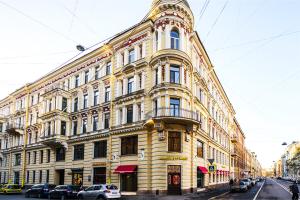un gran edificio amarillo en la esquina de una calle en Atrium Hotel, en San Petersburgo