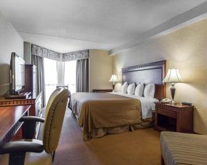 Quality Inn & Suites Bay Front في سولت سانت ماري: غرفه فندقيه سرير وتلفزيون
