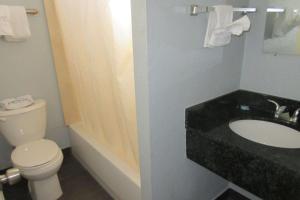 a bathroom with a toilet and a sink at Rodeway Inn San Pablo in San Pablo