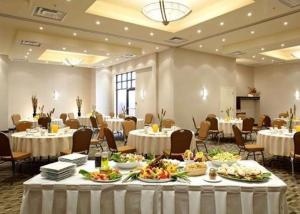 a banquet hall with tables and chairs with food on them at Quality Inn & Suites in Brossard