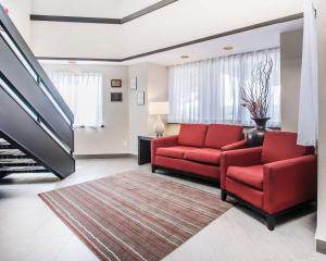 a living room filled with furniture and a red couch at Comfort Inn Edmundston in Edmundston