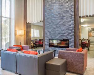 a living room with couches and a fireplace at Comfort Inn Burlington in Burlington