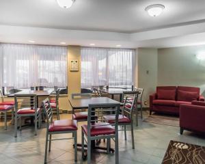 a waiting room with tables and chairs and a couch at Comfort Inn in Pembroke