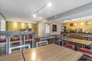 a restaurant with tables and chairs and a bar at Comfort Inn in Sault Ste. Marie