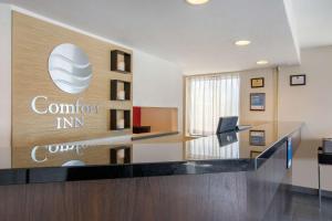an office lobby with a sign on the wall at Comfort Inn Sudbury in Sudbury
