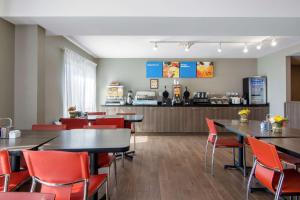 a restaurant with tables and chairs and a counter at Comfort Inn Sudbury in Sudbury