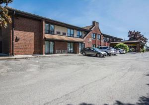 a parking lot in front of a brick building at Comfort Inn in Sherbrooke