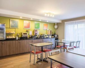 a restaurant with tables and chairs and a counter at Comfort Inn Rimouski in Rimouski