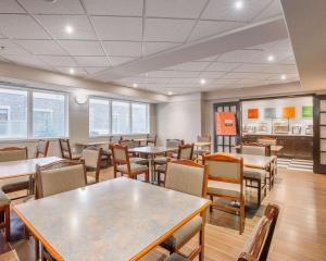 a dining room with tables and chairs at Comfort Inn & Suites University in Calgary