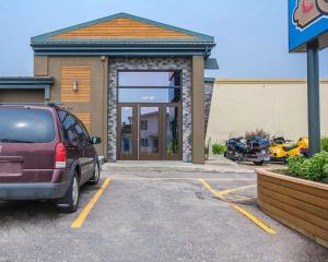 a car parked in a parking lot in front of a building at Econo Lodge Forestville in Forestville