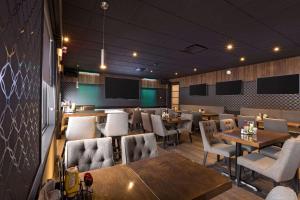 a restaurant with tables and chairs and a chalkboard at Quality Inn & Suites in Matane