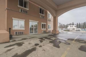 an empty parking lot in front of a building at Comfort Inn & Suites Edson in Edson