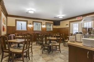 a dining room with tables and chairs in a restaurant at Quality Inn in Rivière-du-Loup