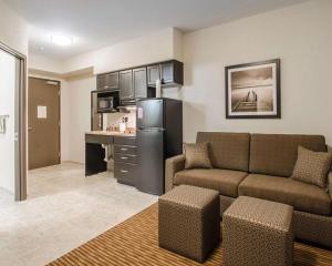 a living room with a couch and a kitchen at Quality Inn & Suites in Estevan