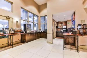 a lobby with a coffee shop with windows at Comfort Inn & Suites Ambassador Bridge in Windsor