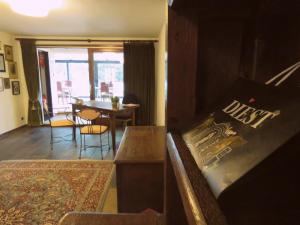 a living room with a couch and a dining room table at Guesthouse La maison de Fille in Diest